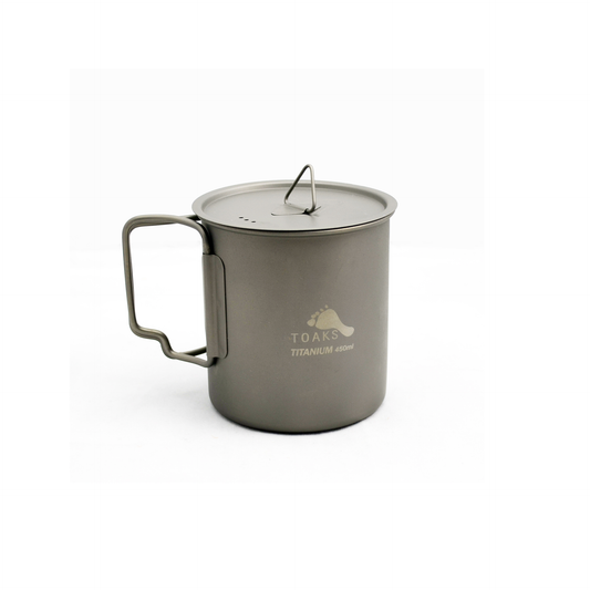 A gray TOAKS Titanium 450ml cup with a lid, featuring a handle and the brand name 'TOAKS TITANIUM' on the side.